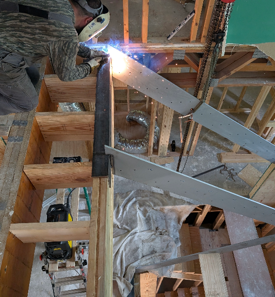 Man Welding Staircase up in the air